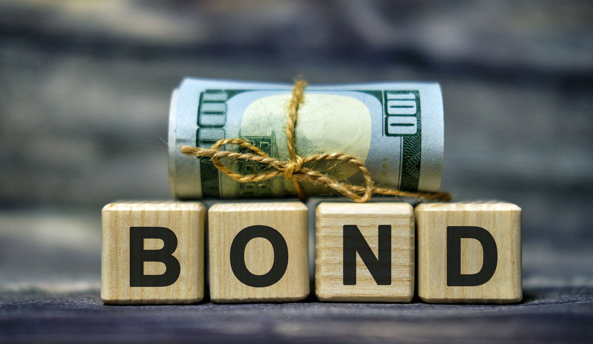 BOND word concept on cubes with a Banknote. Business concept